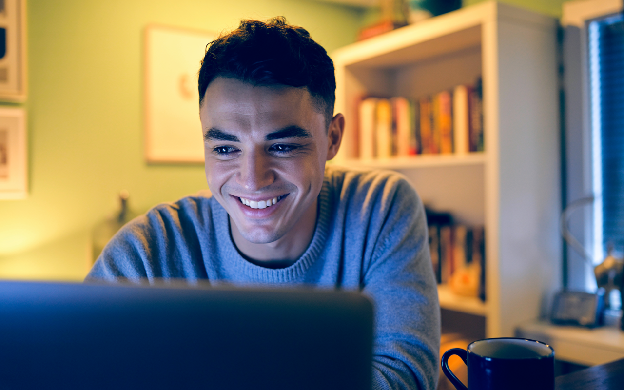 a man looking at a laptop searching information on  mounjaro