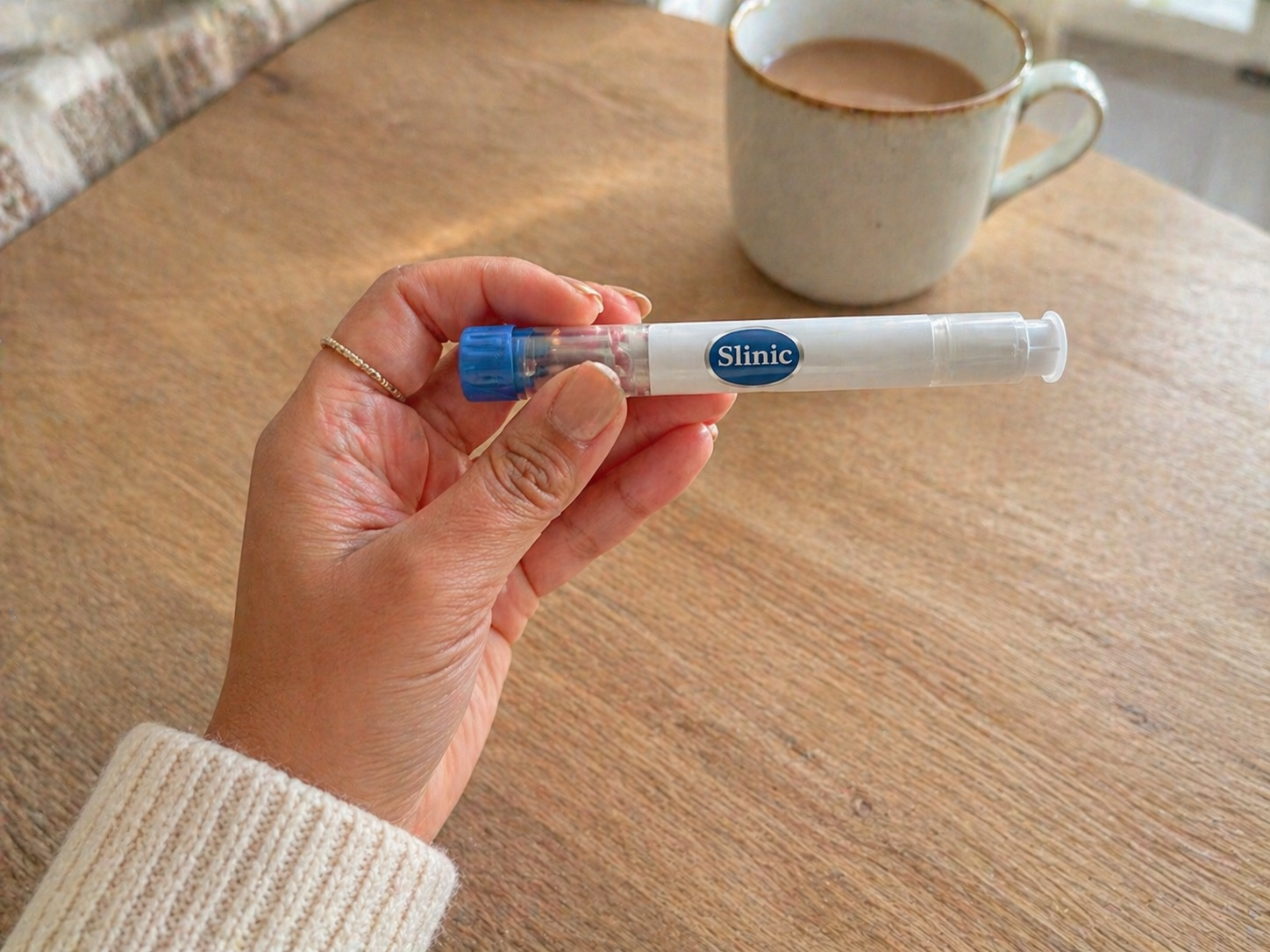 Close-up of Mounjaro KwikPen expiry date label held in hand at a kitchen table before a weekly dose