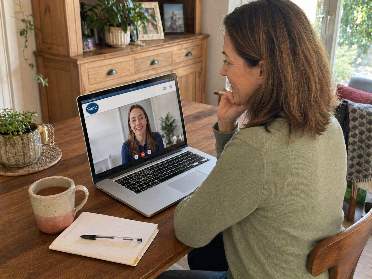 Person on a video call at home with a Slinic pharmacist, discussing Mounjaro storage and treatment questions